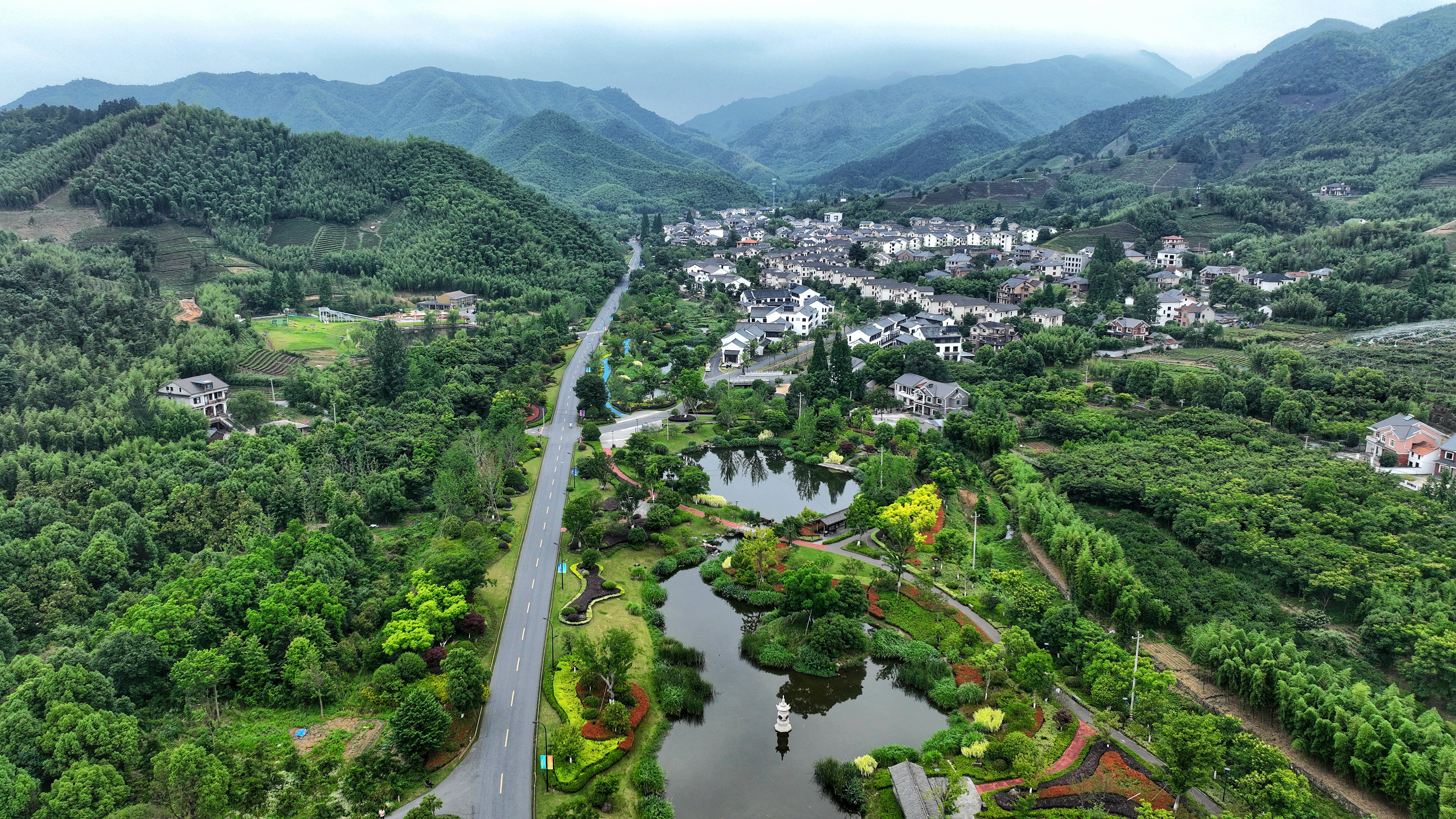 2023年6月6日，杭州余杭區(qū)徑山鎮(zhèn)鄉(xiāng)村，生態(tài)碧水、沿路花海與村莊農(nóng)房相映成趣，構(gòu)成一幅美麗的山水田園畫。